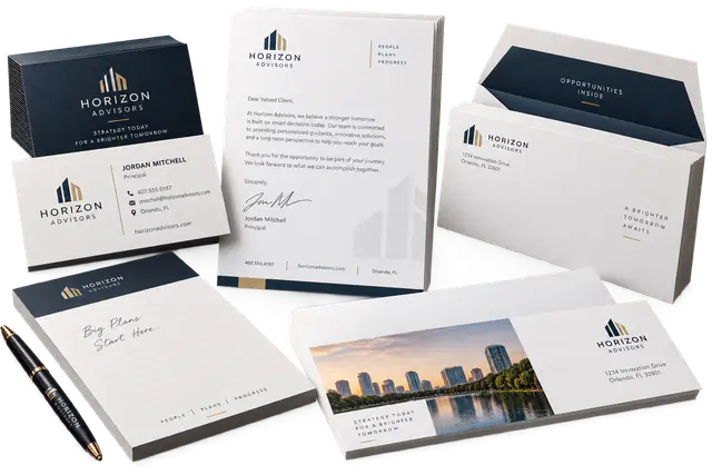 Business cards, letterhead, envelopes, and notepads arranged on a studio surface.