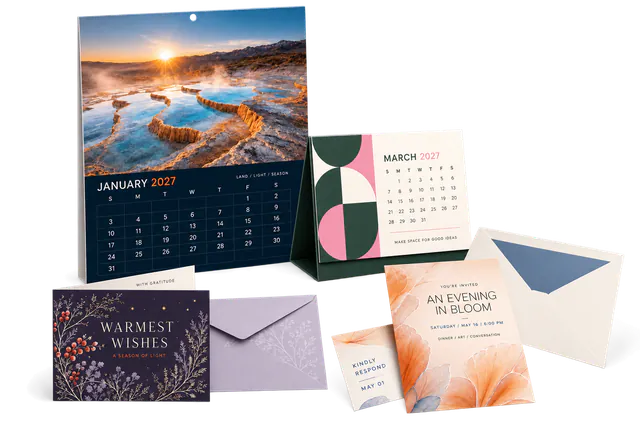 Wall calendars, desk calendars, invitations, and specialty cards arranged on a studio surface.