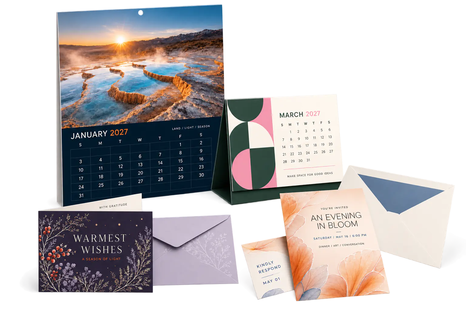 Wall calendars, desk calendars, invitations, and specialty cards arranged on a studio surface.